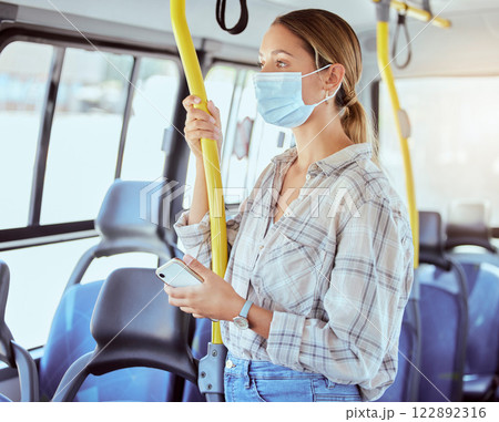 Covid, face mask and public transport with woman in a bus or train on commute into city or work during coronavirus pandemic. Travel, precaution and safety of commuter or passenger female traveling 122892316