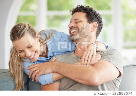 Love, relax and marriage couple hug on sofa together for sweet embrace with cheerful smile. Happy, caring and romantic people in married commitment enjoy bonding time in home living room. 122892574