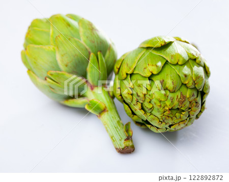 Closeup of ripe artichoke globes on white background Closeup of ripe artichoke globes on white background 122892872