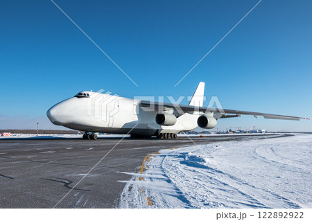 White wide body transport cargo airplane at winter airport White wide body transport cargo airplane at winter airport 122892922