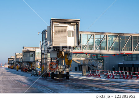 Empty passenger boarding bridges at airport apron at winter 122892952