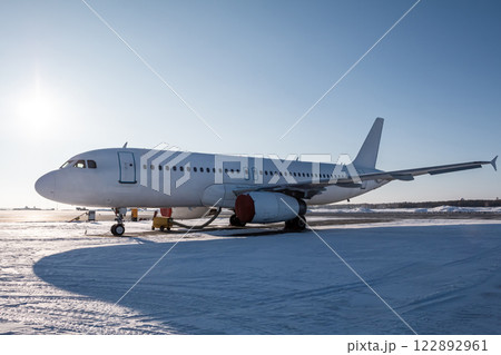 White passenger jetliner on the airport apron at winter 122892961