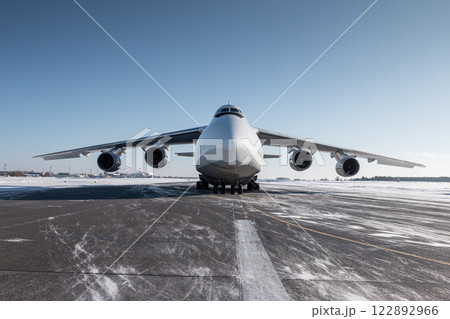 Front view of the white wide body transport cargo airplane at winter airport 122892966