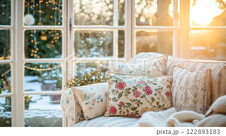 Colorful pillows on sofa against glass wall of window in a winter garden or conservatory. Interior textile concept. High quality photo 122893183
