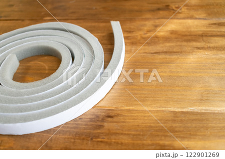 木目の上に置かれたすきまテープ、左 122901269