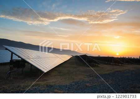 Sunset at Solar power station. Solar panels, photovoltaics, alternative source of electricity - concept of sustainable and renewable sources. Sunset at Solar power station. Solar panels, photovoltaics, alternative source of electricity - concept of sustainable and renewable sources. 122901733