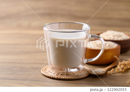 Oat milk in cup glass on wooden background, Alternative milk made from plant, non dairy 122902055