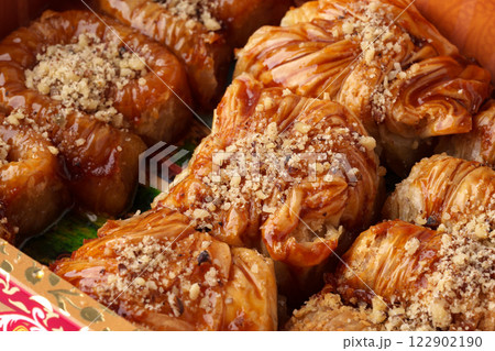 Delicious baklava dessert served on a platter at a festive gathering in a traditional setting Delicious baklava dessert served on a platter at a festive gathering in a traditional setting 122902190