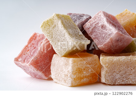 Colorful assortment of traditional sweets arranged on a plain background for a festive display Colorful assortment of traditional sweets arranged on a plain background for a festive display 122902276