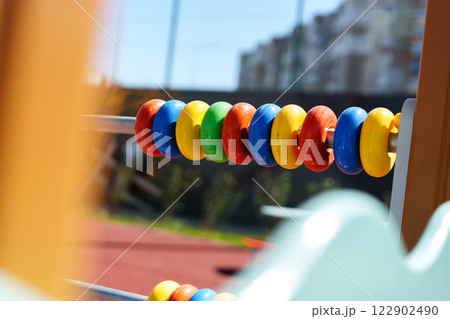 Colorful play equipment at a sunny playground with vibrant rings for children to enjoy and learn Colorful play equipment at a sunny playground with vibrant rings for children to enjoy and learn 122902490