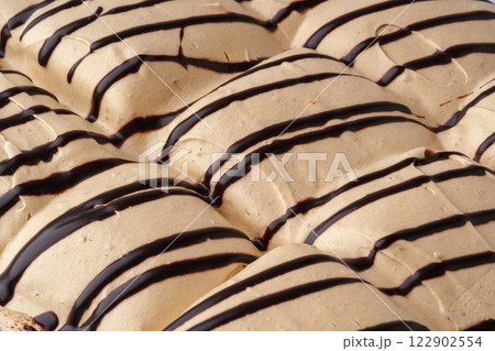 Delicious dessert featuring layers of creamy caramel and chocolate drizzle in a dessert display 122902554