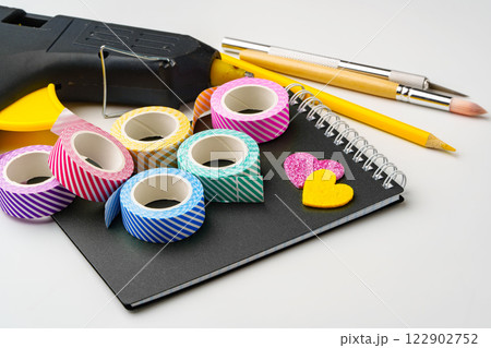 Crafting supplies neatly arranged with colorful tapes and tools on a workspace 122902752