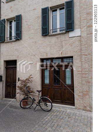 classic bicycle parked against building 122903113