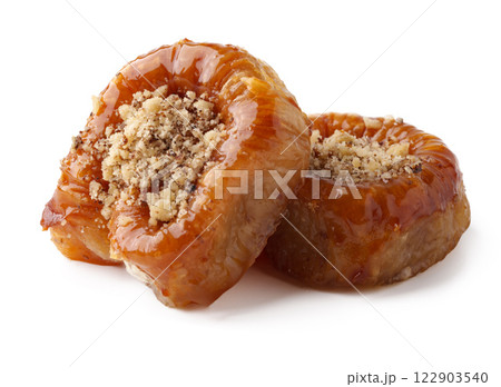 Delightful sweet pastries coated in syrup served on a white background Delightful sweet pastries coated in syrup served on a white background 122903540