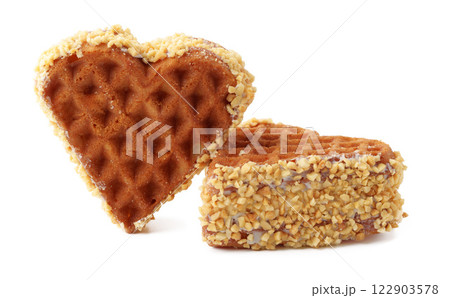 Heart-shaped waffle coated in crushed nuts makes a delightful treat for dessert lovers 122903578