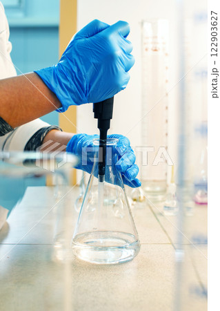 Experimenting with liquid manipulation in a laboratory setting during daylight hours 122903627
