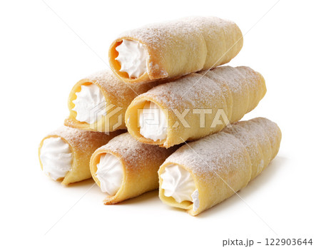 Cream-filled pastries stacked on a white background showcasing a delicious dessert treat 122903644