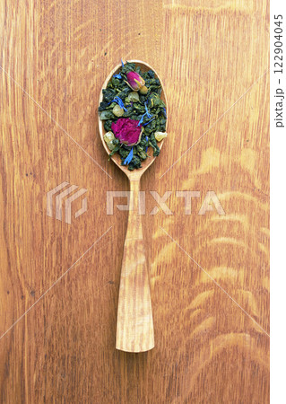 Tea in a wooden spoon on a wood 122904045