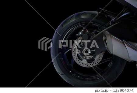 Close-up rear modern motorbike with detail as alloy wheels, disk brake, pump and intake on black colour background 122904074