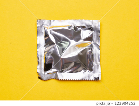 Package on a yellow background 122904252