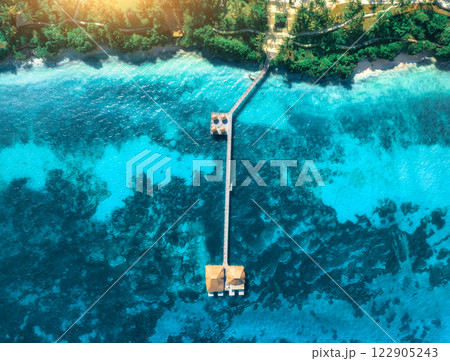 Aerial view of bungalow, white sandy beach, sea and palms 122905243