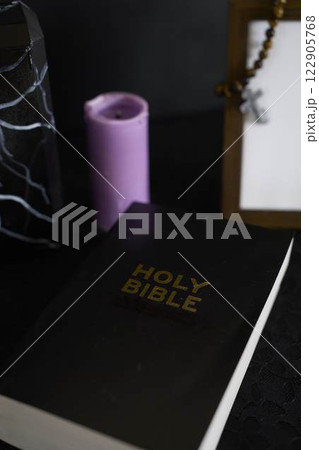 funeral, photo frame, candles, a marble urn for ashes, holy bible and spiritual bracelet with black cross funeral, photo frame, candles, a marble urn for ashes, holy bible and spiritual bracelet with black cross 122905768