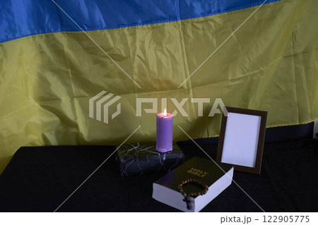 funeral of Ukrainian , photo frame, candles, marble urn for ashes, holy bible and acspiritual bracelet with black cross 122905775