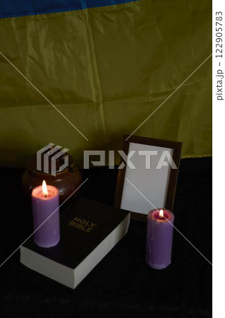 funeral of Ukrainian , photo frame, candles, marble urn for ashes, holy bible and acspiritual bracelet with black cross 122905783