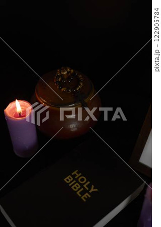 funeral, a photo frame, candles,  urn for ashes, holy bible and spiritual bracelet with black cross 122905784