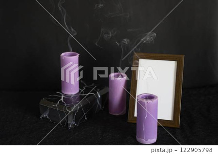 funeral, a photo frame, marble urn for ashes and smoke from extinguished candles, farewell funeral, a photo frame, marble urn for ashes and smoke from extinguished candles, farewell 122905798