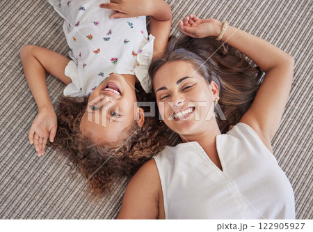 Family, children and love above a girl and mother lying on a bed in the bedroom of their home together from above. Kids, happy and smile with a woman and her cute daughter in their house to relax 122905927