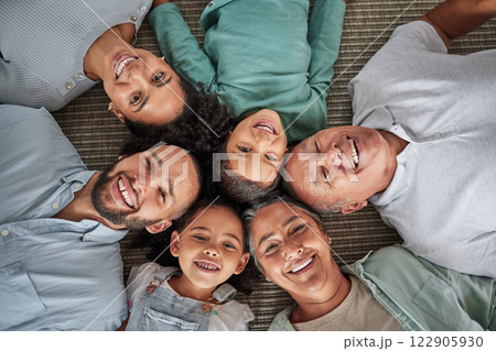 Family floor, happy portrait and grandparents in retirement with children, crazy and comedy together in the living room of home. Kids and parents with smile for weekend with elderly people in house 122905930