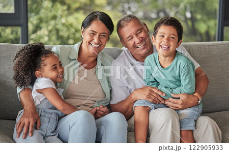 Love, happy family and children bonding with grandparents on sofa at home, laugh and having fun in their family home. Relax, play and excited kids embracing and enjoying a visit to grandparent home 122905933