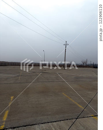Empty parking lot for cars with concrete surface 122906110