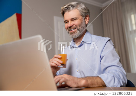 Mature caucasian man working at the laptop and looking confident 122906325