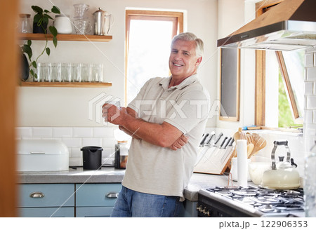 Happy, coffee and retirement with man in kitchen in the morning for breakfast, cooking or health. Relax, smile and diet with senior male at home drinking tea for wellness, nutrition and lifestyle 122906353
