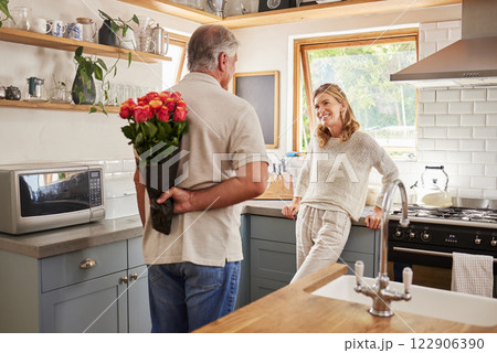 Senior, couple and flowers for love in kitchen, husband with bouquet of roses to wow wife, happy and marriage on wedding anniversary. Man, flowers and woman together, romance and surprise in home Senior, couple and flowers for love in kitchen, husband with bouquet of roses to wow wife, happy and marriage on wedding anniversary. Man, flowers and woman together, romance and surprise in home 122906390