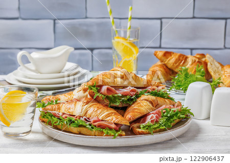 croissant sandwiches with ham and lettuce on plate croissant sandwiches with ham and lettuce on plate 122906437