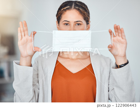 Business woman, portrait and mask in end of covid taking off face protection against blurred background. Female employee free from corona virus holding and stretching masks of ending or stop pandemic 122906443