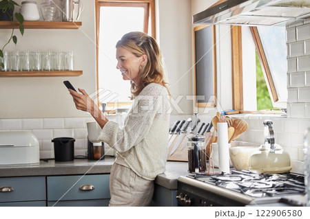 Mature woman reading phone news, social media notification and mobile apps in Australia kitchen home. Happy lady typing smartphone, online social network and 5g web technology connection in apartment 122906580