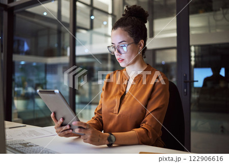 Woman working in Toronto office at night, big data analytics and reading expert research on digital tablet. Database administrator in dark, overtime work on company report and iot in tech business 122906616