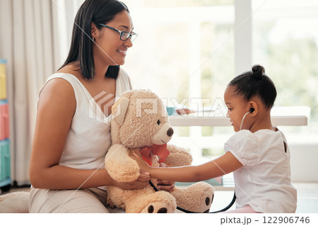Teddy bear doctor, girl game and mother with smile for child, happy medical work and family love for healthcare in home. Girl and mom giving support and help playing nurse to toys in house together 122906746