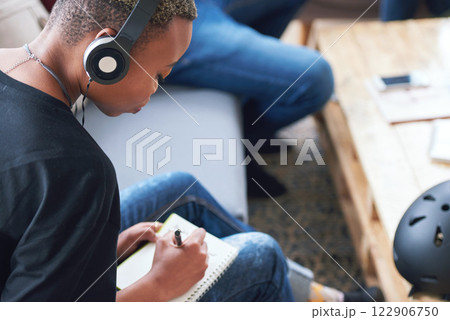 Writing, notebook or black woman or student with planning, learning and listening to music, podcast or radio in class. Studying, research and creative girl with book for university, college or school 122906750