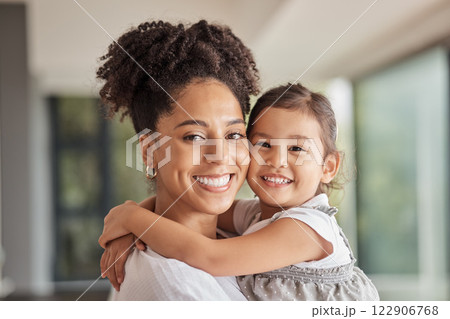 Family, love and bond of mother and daughter sharing a hug, happiness and having fun on mothers day in their puerto rico home. Portrait and smile of woman and foster girl child bonding after adoption Family, love and bond of mother and daughter sharing a hug, happiness and having fun on mothers day in their puerto rico home. Portrait and smile of woman and foster girl child bonding after adoption 122906768