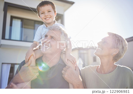 Children, family and love with a boy and his grandparents playing outside in the garden of their home during a visit. Kids, happy and senior with a male child on the shoulders of his grandfather Children, family and love with a boy and his grandparents playing outside in the garden of their home during a visit. Kids, happy and senior with a male child on the shoulders of his grandfather 122906981