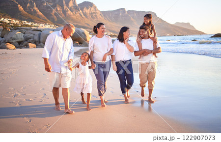 Big family, children or girls bonding on beach on summer sunset holiday, social reunion or vacation. Smile, happy and walking parents, mom and dad with relax senior grandparents and kids in Cape Town 122907073