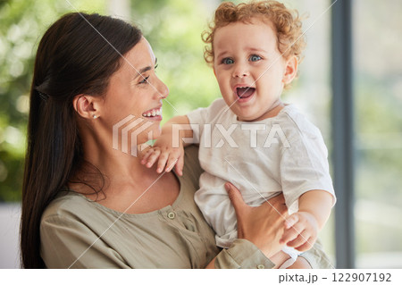 Love, happy and mother with adoption baby relaxing in interracial family home to bond together. Care, support and joy of Brazilian mom smiling while holding foster child in arms at house. Love, happy and mother with adoption baby relaxing in interracial family home to bond together. Care, support and joy of Brazilian mom smiling while holding foster child in arms at house. 122907192
