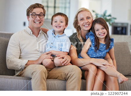 Parents, kids and family portrait in home lounge on sofa together to enjoy relax, bonding and fun quality time together. Happy parents, smile children and love with care, happiness and joy lifestyle 122907244