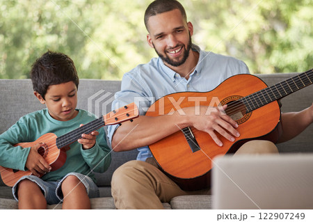 Father teaching child guitar, learning music skill in brazil home and happy singing together. Acoustic musical instrument, young guitarist plays ukulele and training with musician dad in fun family Father teaching child guitar, learning music skill in brazil home and happy singing together. Acoustic musical instrument, young guitarist plays ukulele and training with musician dad in fun family 122907249