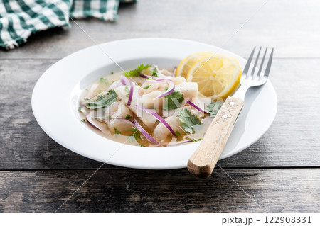 Traditional Peruvian ceviche sea bass fillet on wooden table Traditional Peruvian ceviche sea bass fillet on wooden table 122908331